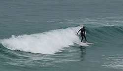 surfer catching a wave at Newquay